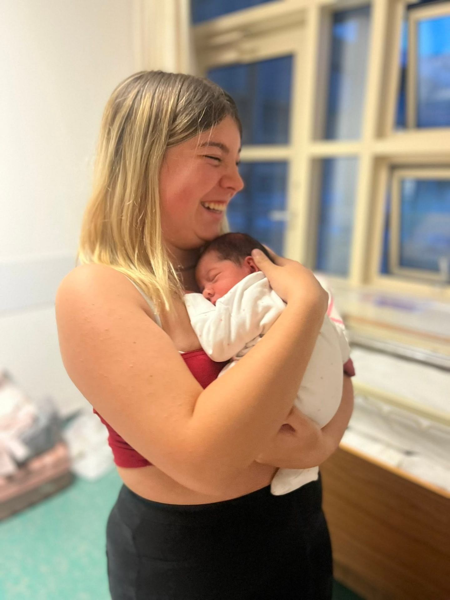 My eldest cradling my youngest. Richest woman in the world — this is everything to me.